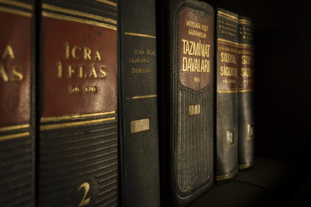Shelves of leather-bound law books in warm library light
